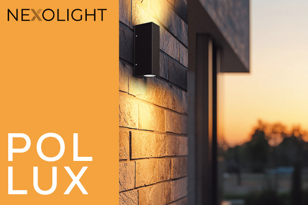 Nexolight Pollux outdoor wall light with up and down light on a modern brick facade at sunset