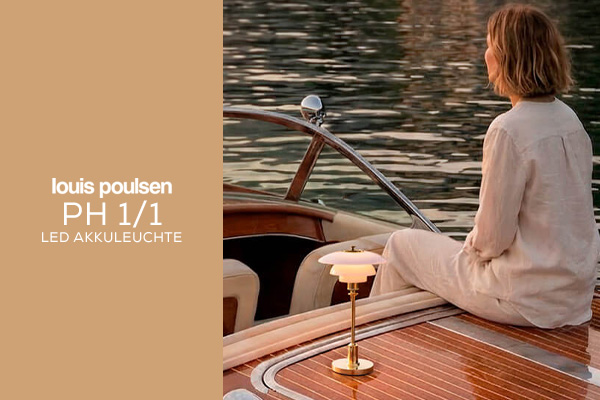 Louis Poulsen PH 1/1 LED Akkuleuchte als stilvolle Tischleuchte auf klassischem Boot am Wasser