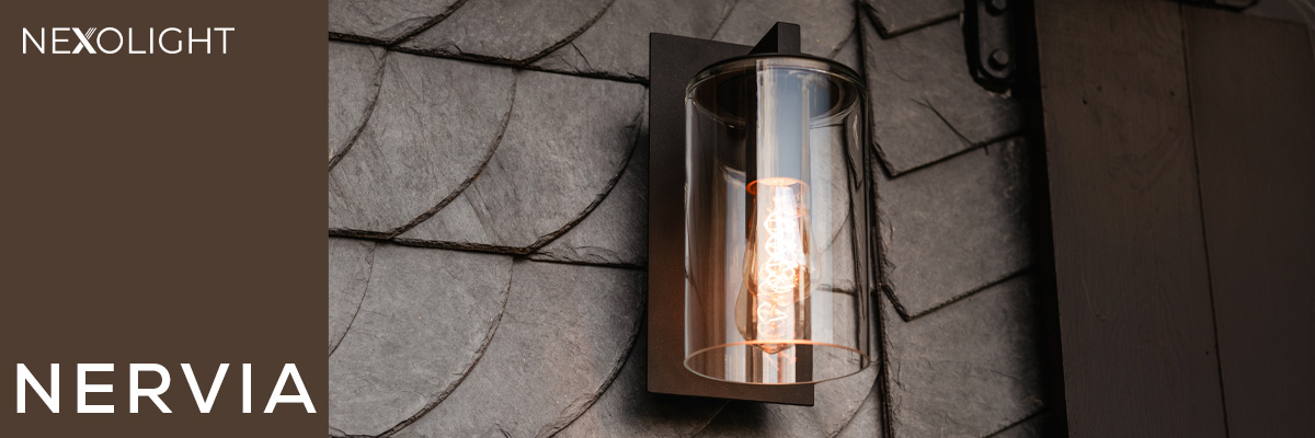 Nexolight Nervia outdoor wall light with glass cylinder and warm light on a slate facade